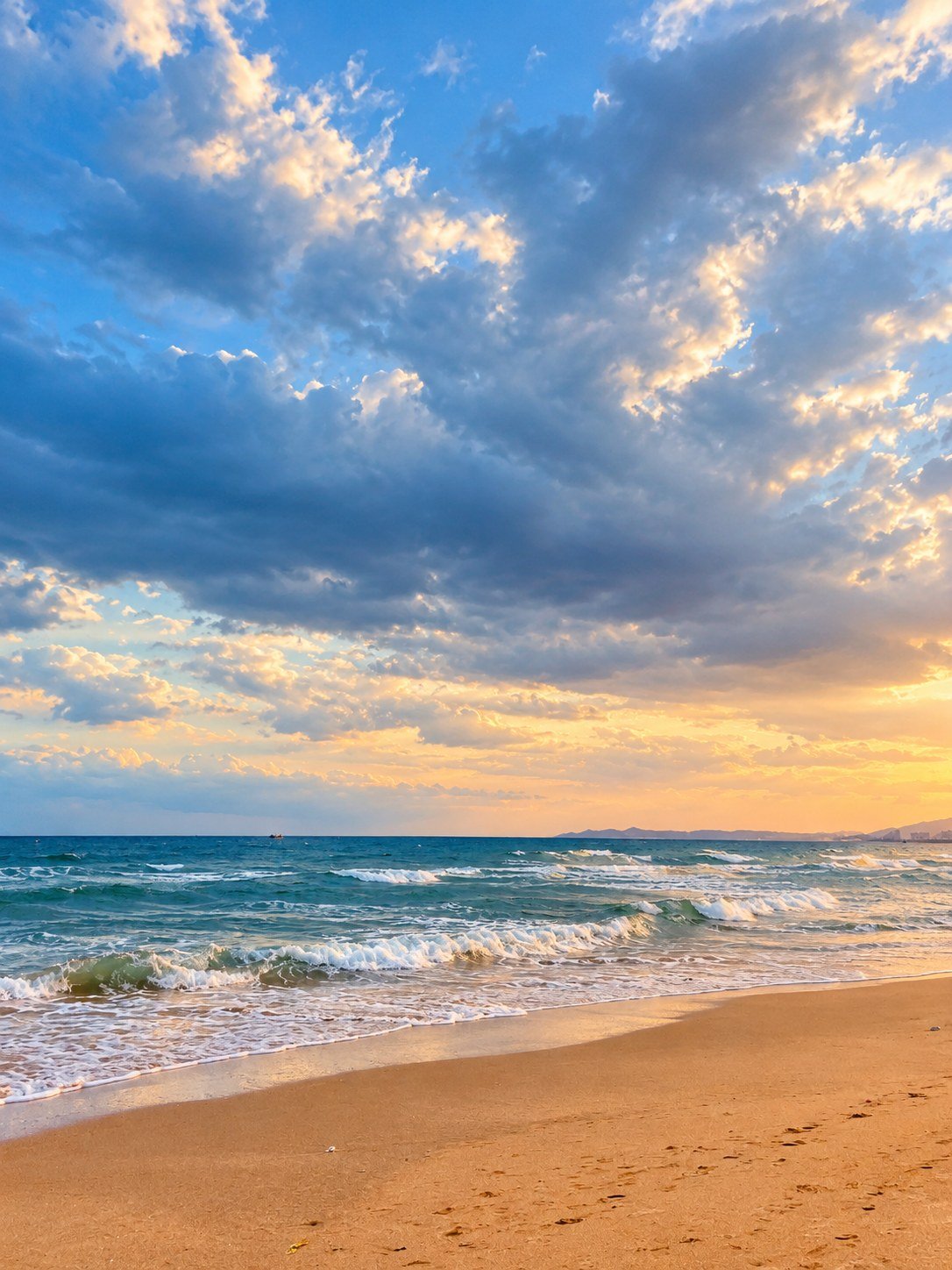 Waves and sand at sunset