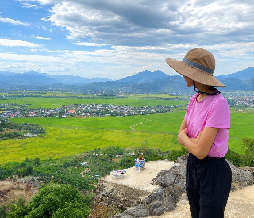 Trang Nguyen looking out over rice fields and mountains